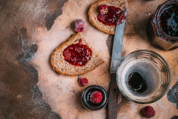 Coffee and toast with raspberry jam