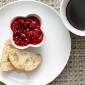 Light breakfast with fresh bread, homemade raspberry jam, coffee .