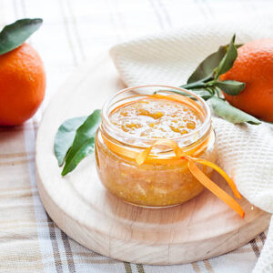 Orange jam in glass jar, selective focus.