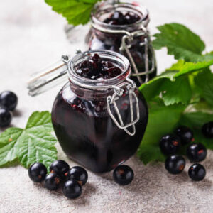 Black currant jam in jar. selective focus